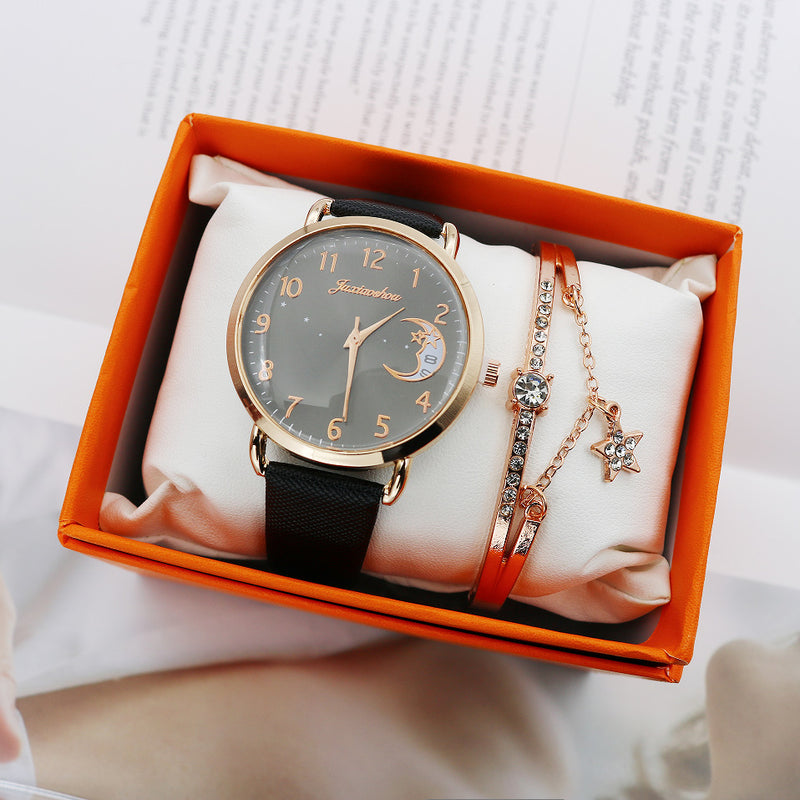 Black celestial moon quartz watch with a gold-tone case, matching crystal bracelet and orange presentation box.