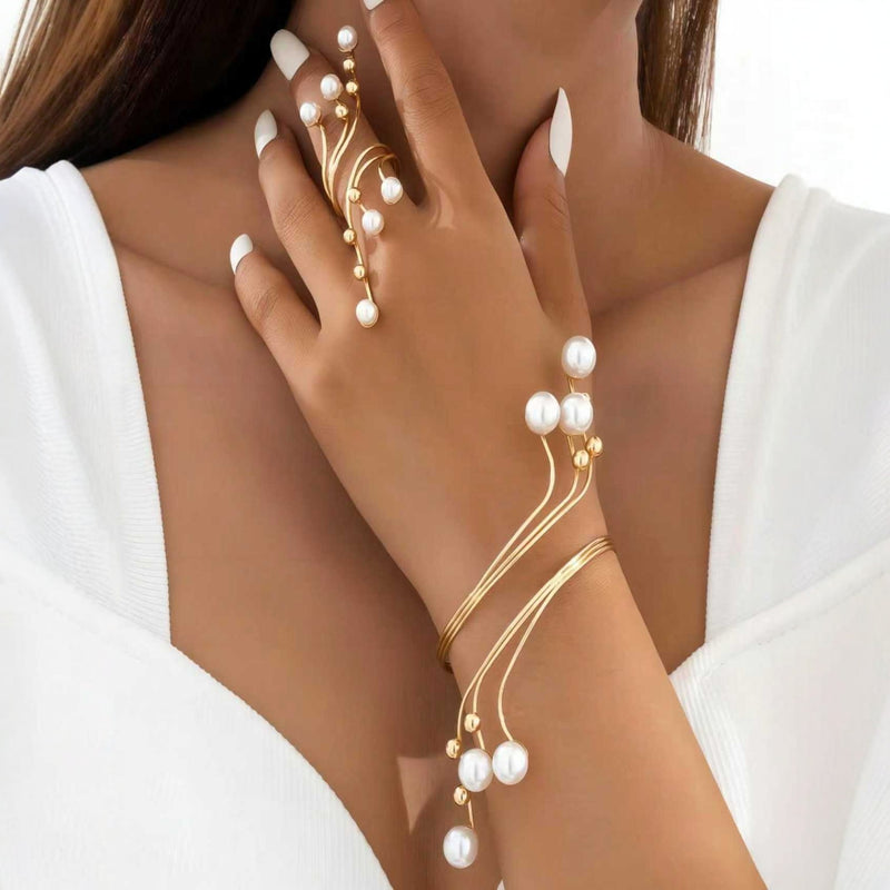 Gold-tone pearl hand chain bracelet for women with elegant flowing wire design