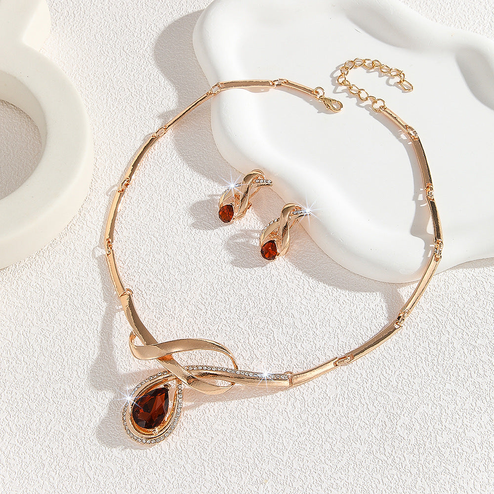Elegant rose gold twisted jewelry set with glossy teardrop amber crystal, formal wedding dinner gift for women